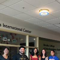 Students posing for a picture by the Padnos International Center in Lake Ontario at GVSU during orientation